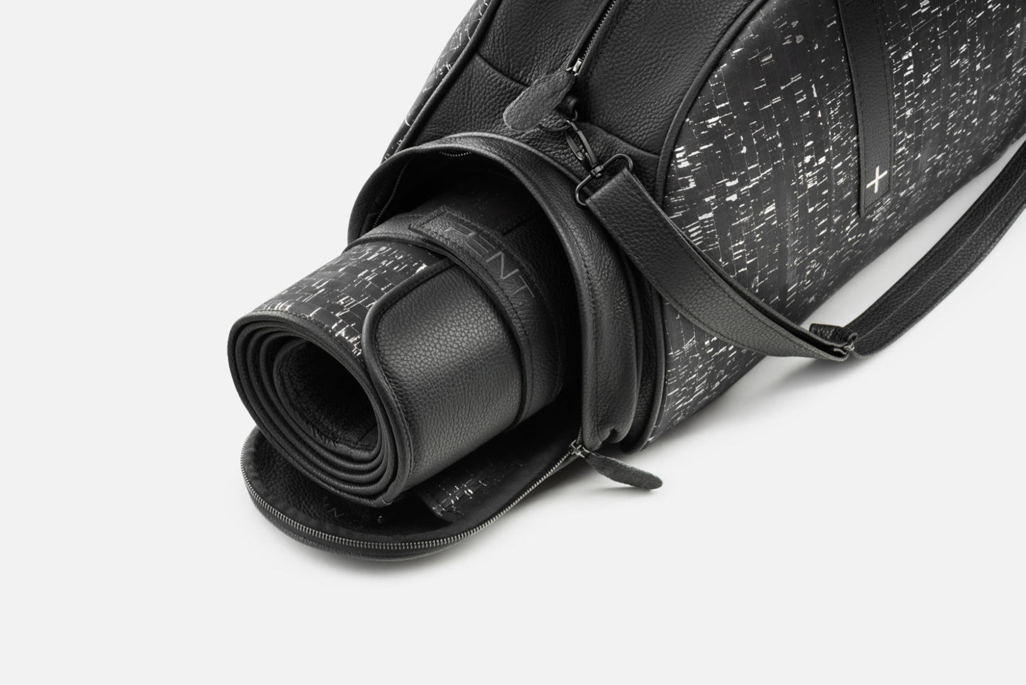"TORBA fitness bag with rolled yoga mat compartment, crafted in genuine leather and cork accents for stylish functionality."